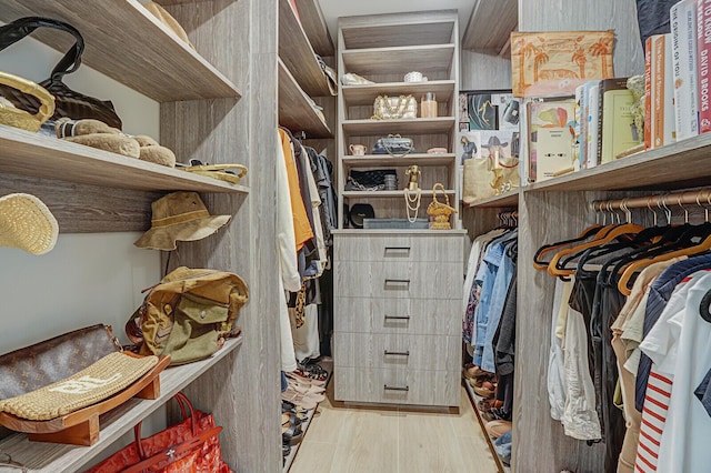 walk in closet with light wood-type flooring