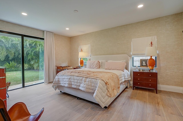 bedroom with light wood-style floors, access to outside, and recessed lighting