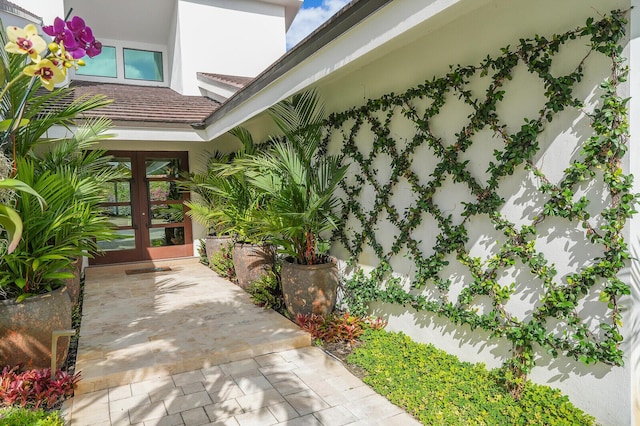 property entrance with french doors and stucco siding