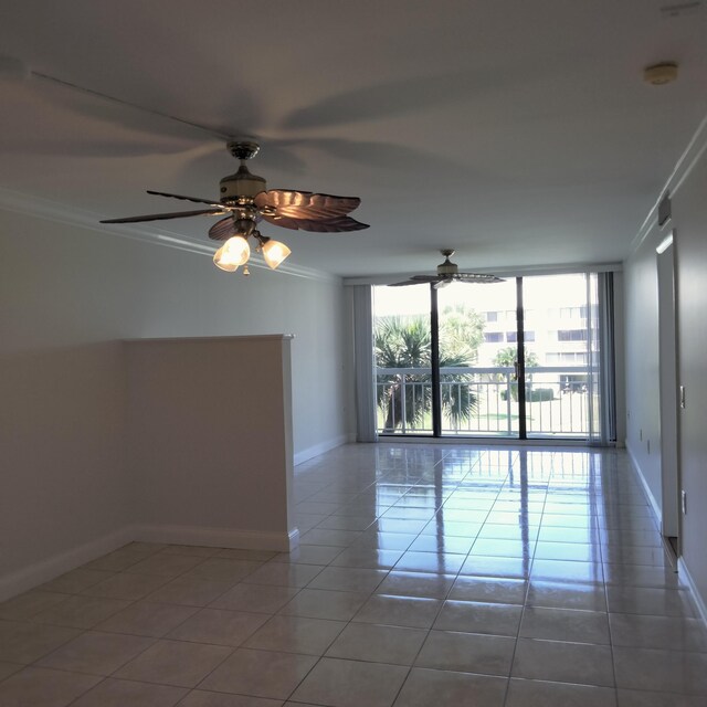 2441 Village Blvd Unit 306, West Palm Beach, FL 33409 - tiled empty room featuring a healthy amount of sunlight, baseboards, crown molding, and visible vents