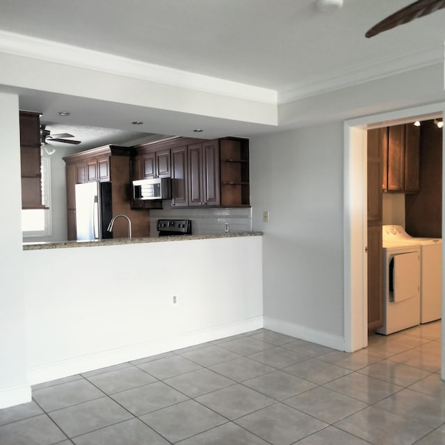 kitchen with light stone countertops, independent washer and dryer, stainless steel appliances, a ceiling fan, and open shelves