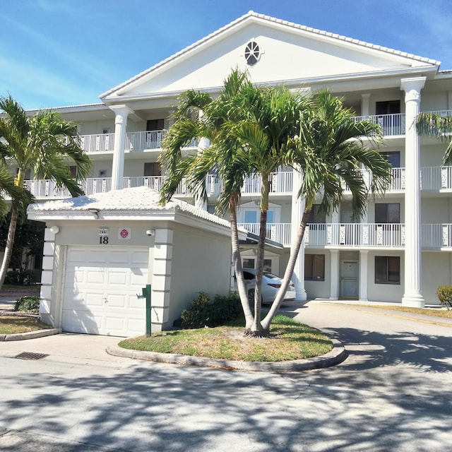 view of building exterior featuring a garage and driveway