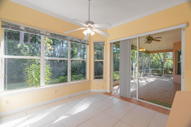 unfurnished sunroom featuring ceiling fan