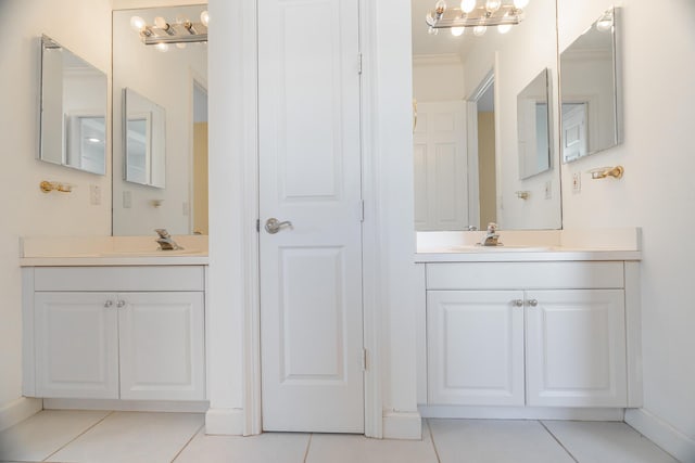 bathroom with tile patterned flooring, vanity, and crown molding