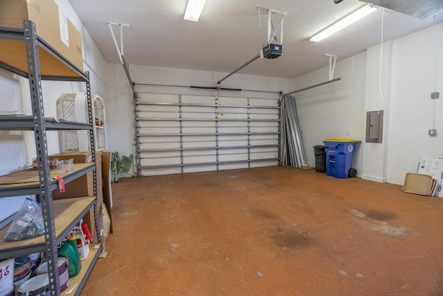 garage with electric panel and a garage door opener