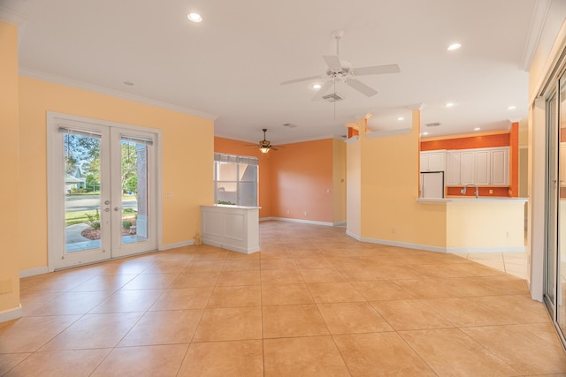 tiled empty room featuring ceiling fan, french doors, sink, and ornamental molding