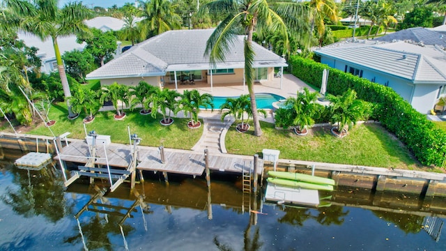 850 Holly Ln, Boca Raton, FL 33486 - dock area featuring a water view, a patio area, a fenced backyard, and a lawn