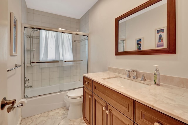 full bathroom featuring vanity, bath / shower combo with glass door, and toilet