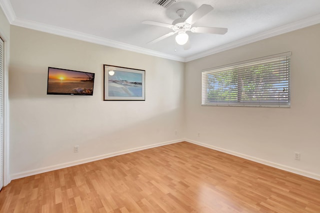 empty room with light hardwood / wood-style floors, ceiling fan, and crown molding