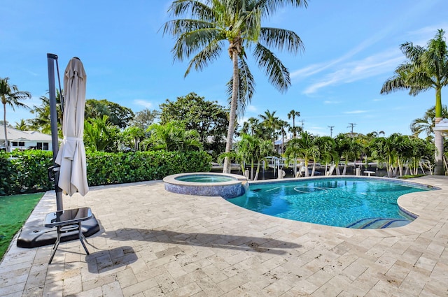 view of swimming pool with a patio area and an in ground hot tub