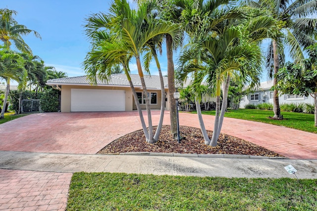 view of front of home featuring a garage and a front lawn