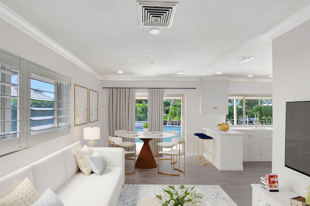 850 Holly Ln, Boca Raton, FL 33486 - living area featuring ornamental molding, visible vents, light wood finished floors, and recessed lighting
