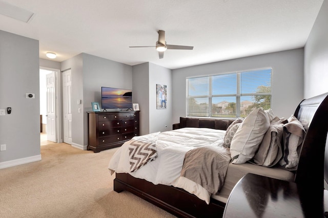 bedroom with light colored carpet and ceiling fan