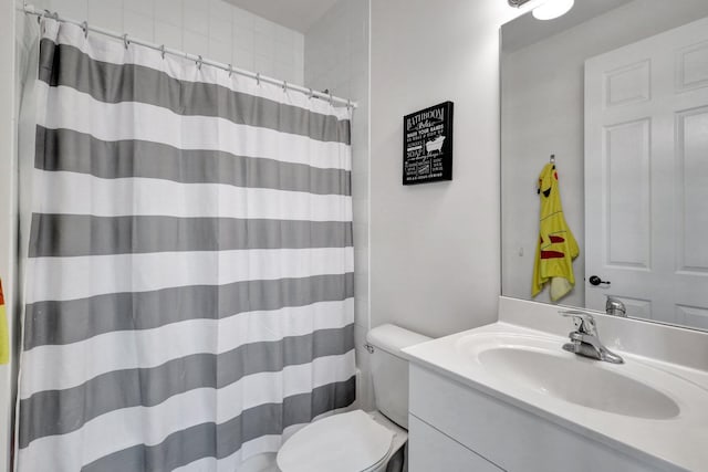 bathroom with vanity, walk in shower, and toilet