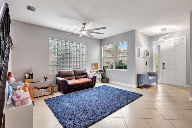 living room with ceiling fan and light tile patterned floors