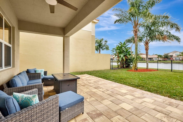 view of patio featuring outdoor lounge area, ceiling fan, and a water view