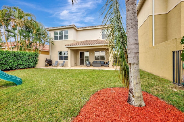 rear view of property with an outdoor living space, a patio, and a yard