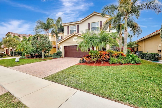 mediterranean / spanish-style house with a garage and a front lawn