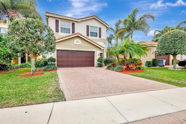 mediterranean / spanish house with a garage and a front lawn