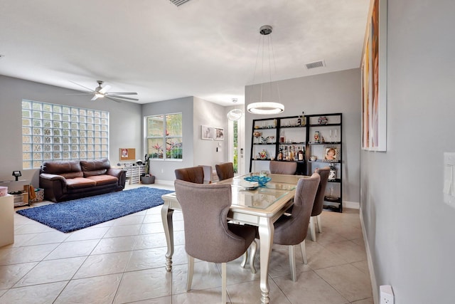 tiled dining area with ceiling fan