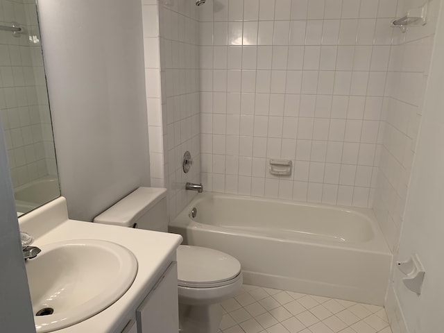 full bathroom featuring tile patterned flooring, vanity, toilet, and tiled shower / bath