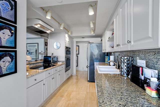 kitchen featuring black electric stovetop, backsplash, exhaust hood, sink, and white cabinetry