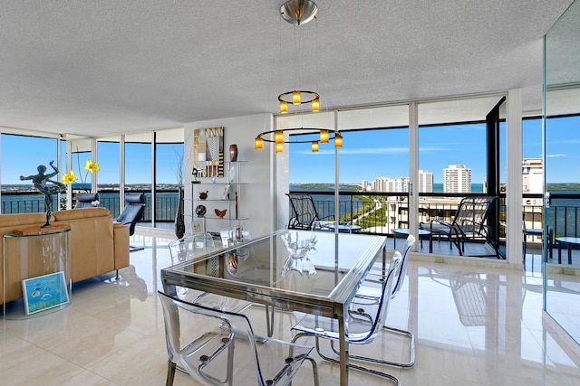 tiled dining room featuring a textured ceiling, plenty of natural light, and expansive windows