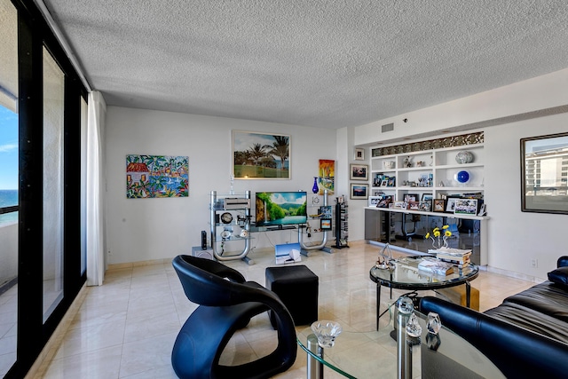 living room featuring a textured ceiling and built in features