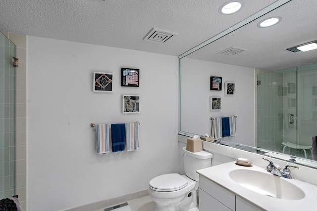 bathroom with vanity, tile patterned floors, toilet, a textured ceiling, and walk in shower