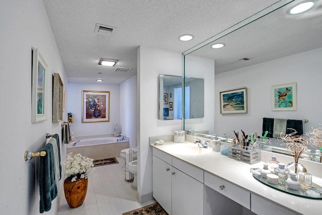 bathroom featuring a tub, tile patterned floors, a bidet, a textured ceiling, and toilet