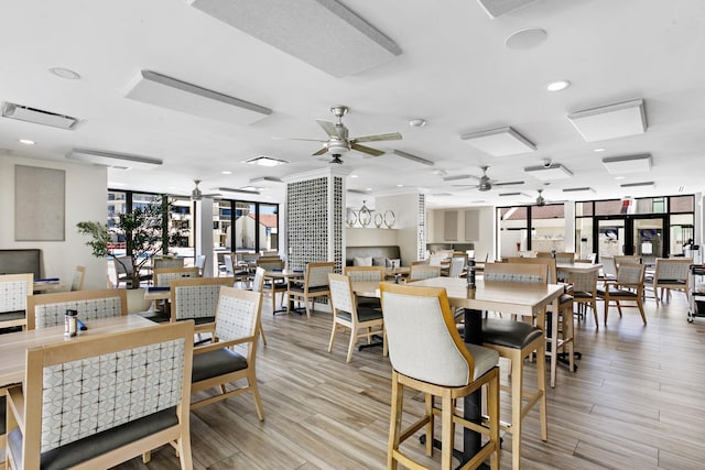 dining room with floor to ceiling windows and ceiling fan