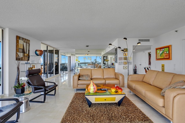 living room with a textured ceiling and expansive windows