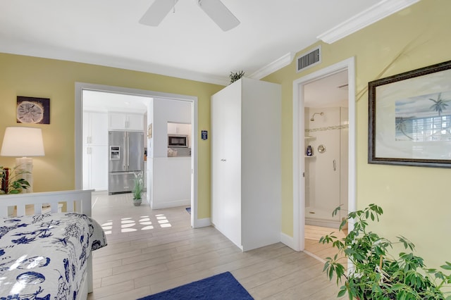 bedroom featuring stainless steel fridge, light wood-type flooring, ensuite bathroom, ornamental molding, and ceiling fan