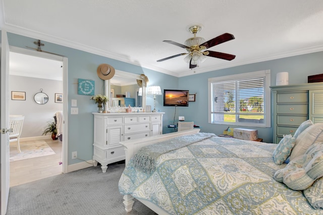 bedroom featuring ceiling fan, crown molding, and light carpet