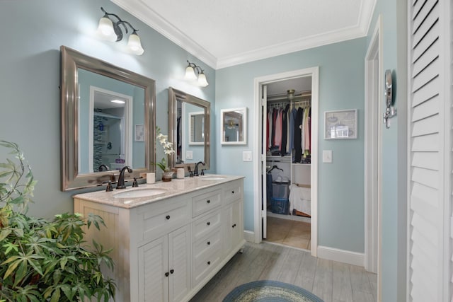 bathroom featuring a textured ceiling, vanity, wood-type flooring, and crown molding