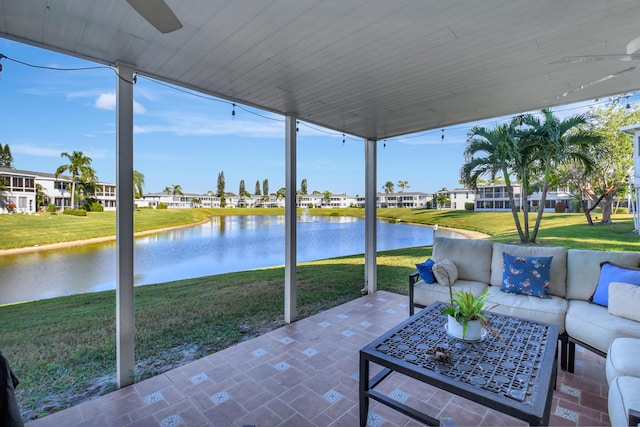 view of patio featuring an outdoor living space, a water view, and ceiling fan