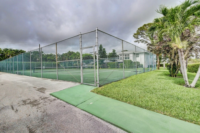 view of sport court featuring a yard