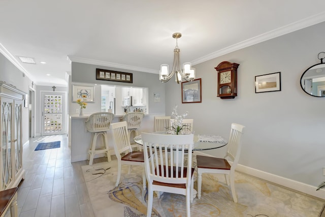 dining area with a chandelier and crown molding