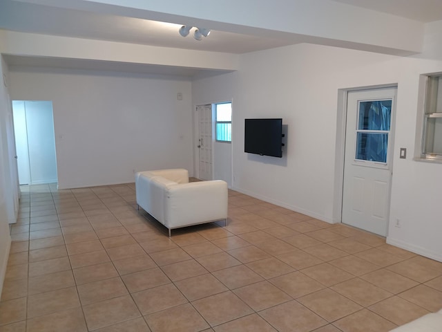 unfurnished living room with light tile patterned floors