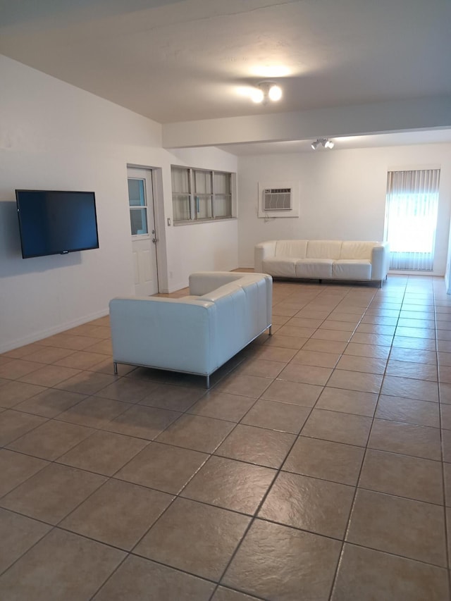 unfurnished living room with tile patterned flooring and a wall unit AC