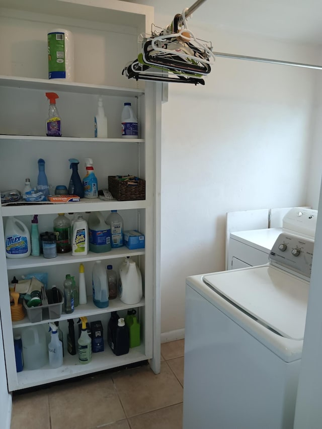 laundry area with tile patterned floors and washer and clothes dryer