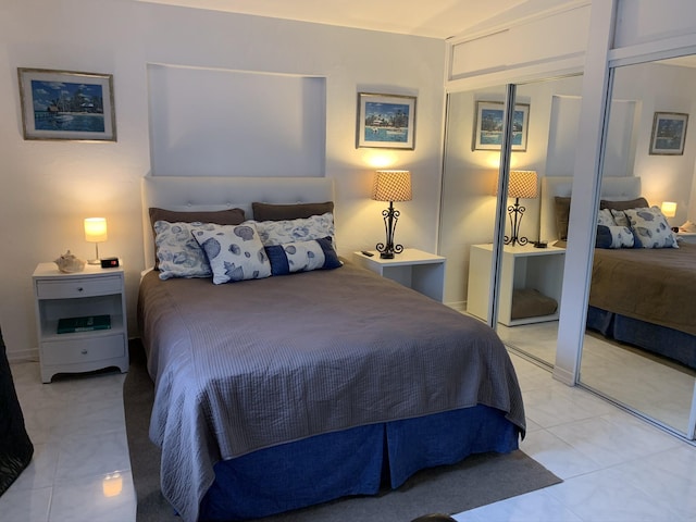 bedroom with light tile patterned floors and a closet