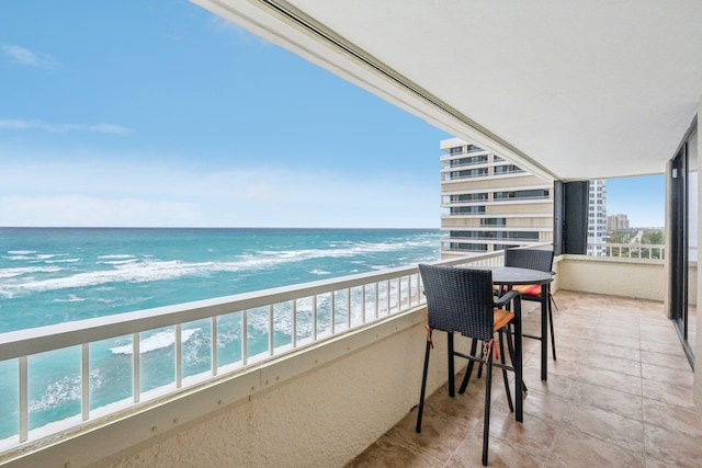 balcony with a view of the beach and a water view