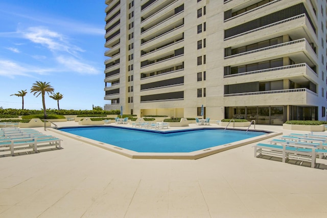 view of swimming pool with a patio