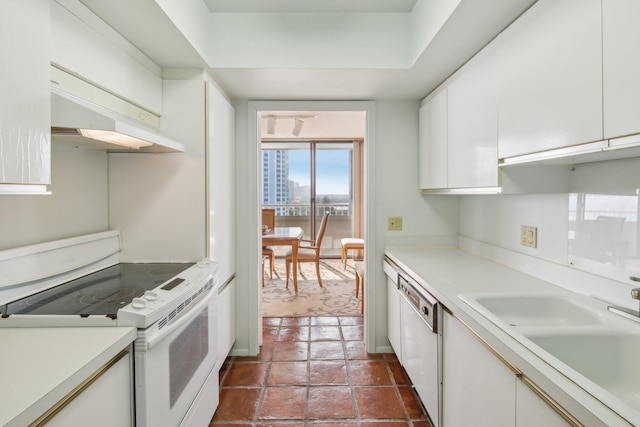 kitchen featuring white cabinets, white appliances, and sink