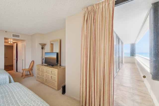 carpeted bedroom featuring a textured ceiling