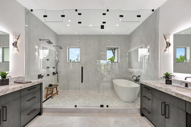 bathroom featuring vanity, plus walk in shower, and tile walls