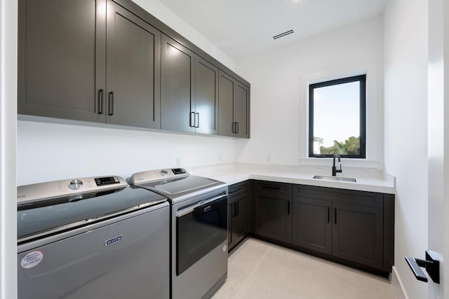 washroom featuring washer and clothes dryer, cabinets, and sink