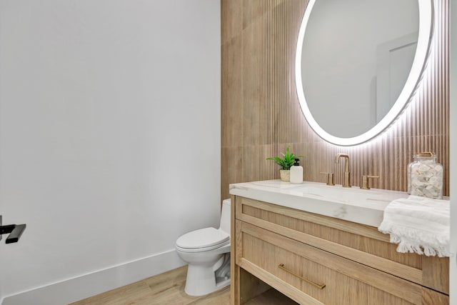 bathroom featuring hardwood / wood-style floors, vanity, and toilet