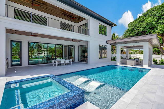 view of swimming pool featuring an in ground hot tub, ceiling fan, and a patio area